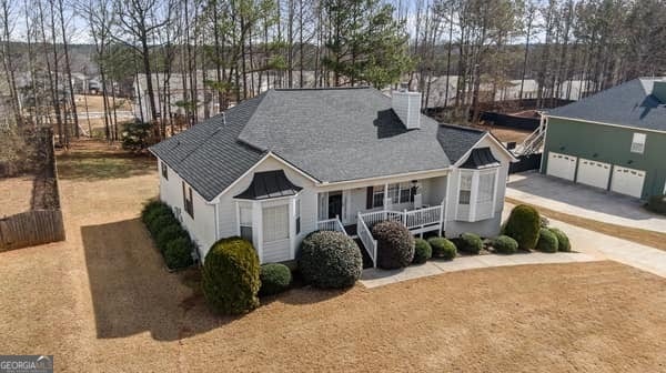 view of front of house featuring a garage, a porch, and concrete driveway