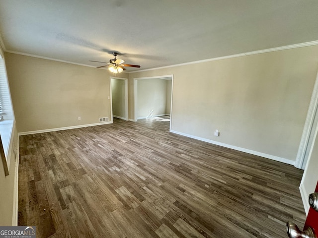 unfurnished living room with baseboards, dark wood-style flooring, and crown molding