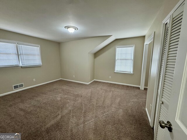 2430 Fern Valley Ct, East Point, GA 30344 - unfurnished bedroom featuring multiple windows, carpet floors, and a closet