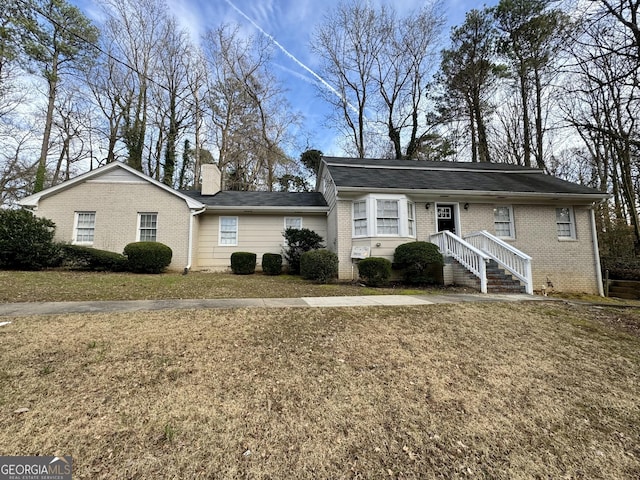 2430 Fern Valley Ct, East Point, GA 30344 - ranch-style home with brick siding, a chimney, and a front yard