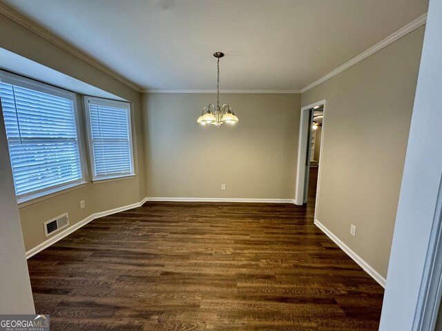 2430 Fern Valley Ct, East Point, GA 30344 - unfurnished dining area with a chandelier, ornamental molding, and dark wood-style flooring