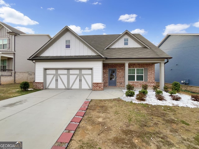 view of front facade with an attached garage, driveway, board and batten siding, and brick siding