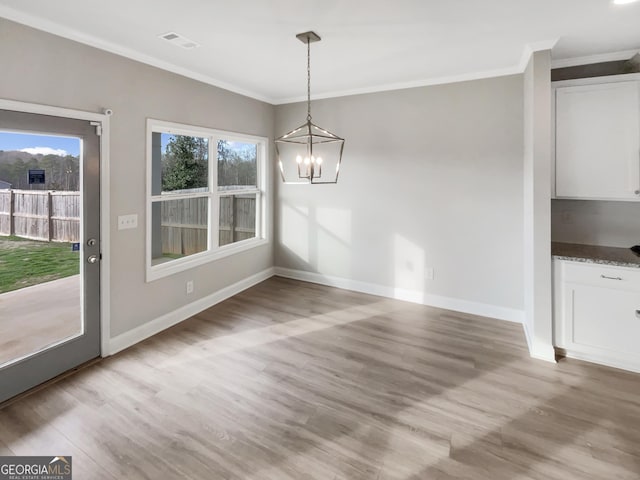 unfurnished dining area featuring ornamental molding, a healthy amount of sunlight, and visible vents