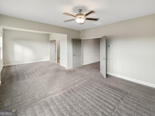 unfurnished bedroom with ceiling fan, carpet floors, visible vents, and baseboards