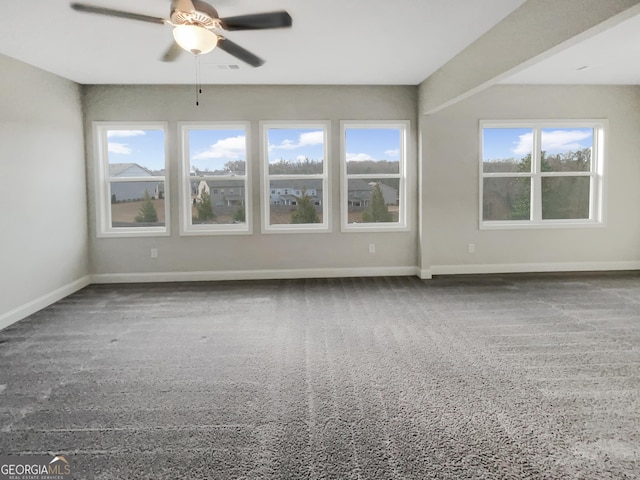 empty room with visible vents, baseboards, and a ceiling fan