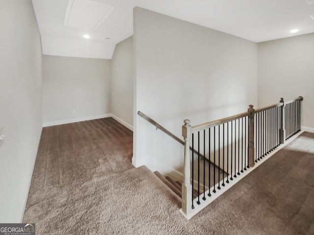 interior space featuring lofted ceiling, carpet flooring, and baseboards