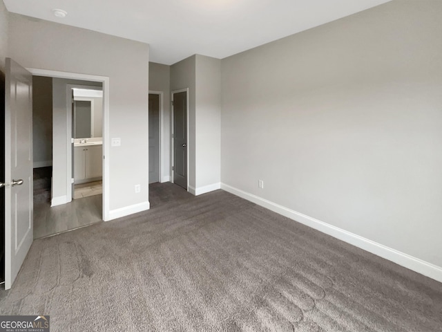 unfurnished bedroom featuring carpet and baseboards