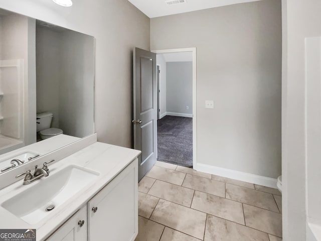 bathroom with visible vents, vanity, toilet, and tile patterned floors