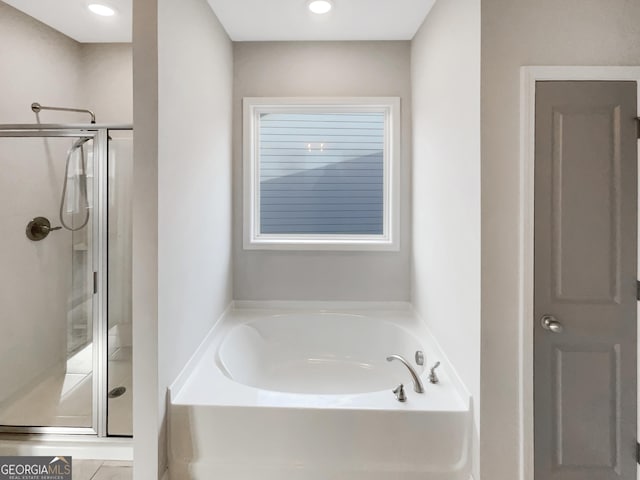 full bathroom with recessed lighting, a garden tub, and a shower stall