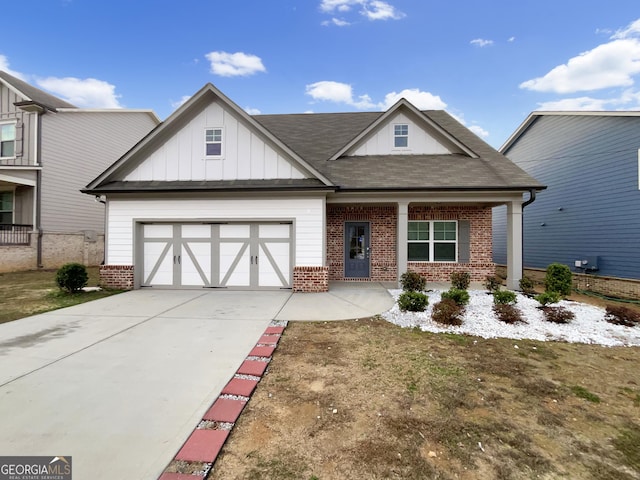 view of front of property featuring board and batten siding, brick siding, driveway, and an attached garage