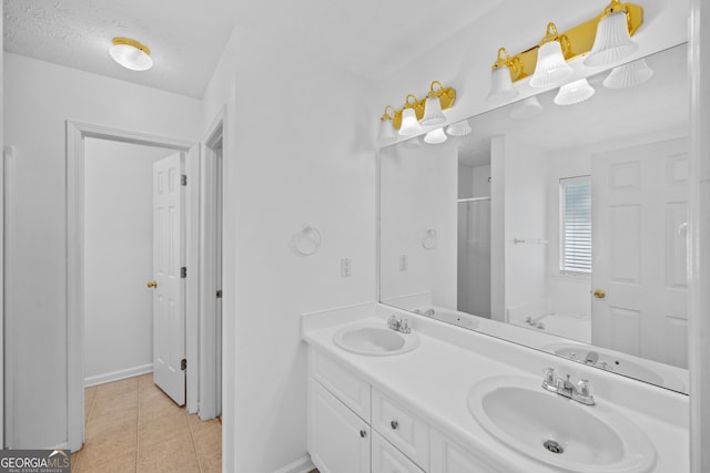 full bath with double vanity, an enclosed shower, a sink, and tile patterned floors