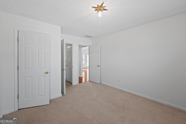 unfurnished bedroom with carpet and baseboards