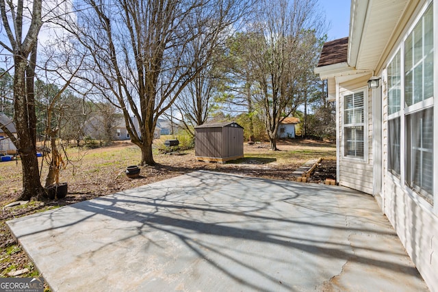 view of patio featuring a storage shed and an outbuilding