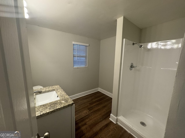 645 Steve Dr SW, Atlanta, GA 30315 - full bath featuring vanity, a shower, and wood finished floors