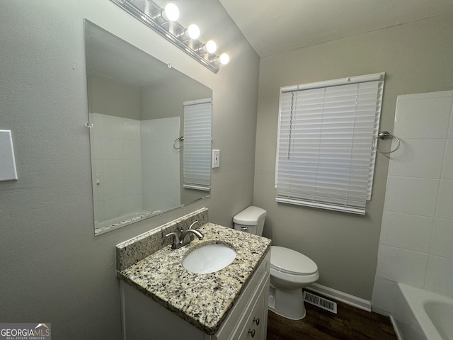 full bath with visible vents, toilet, vanity, wood finished floors, and baseboards