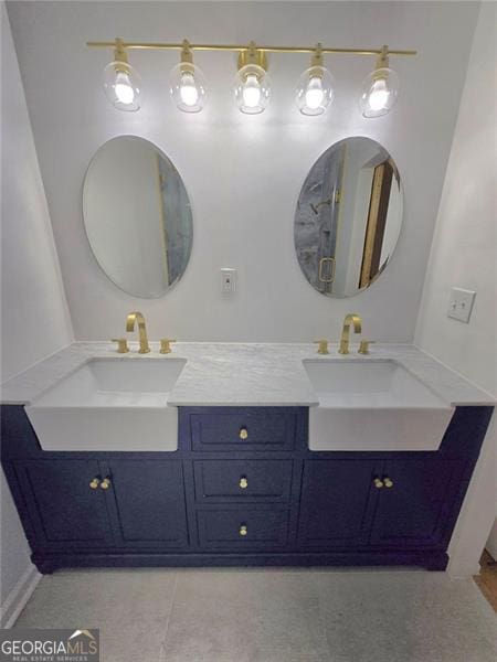 full bathroom featuring double vanity, a sink, and tile patterned floors