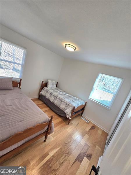 bedroom featuring baseboards and light wood-style floors