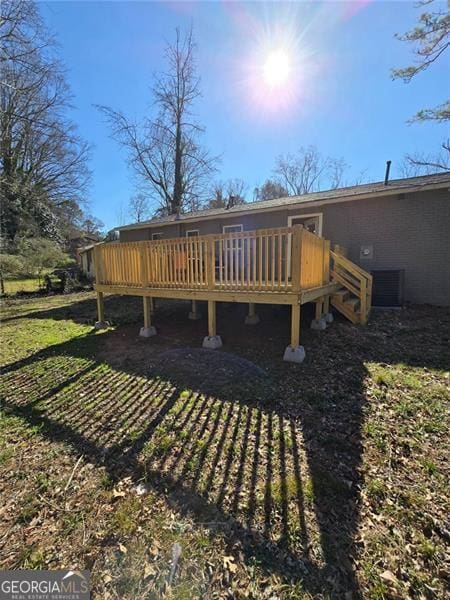 wooden terrace featuring a yard