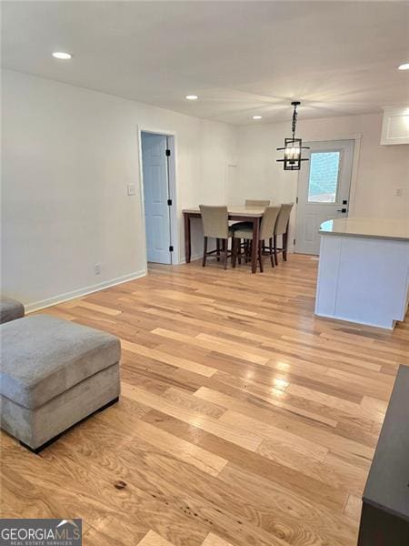 interior space featuring light wood-type flooring, baseboards, and recessed lighting