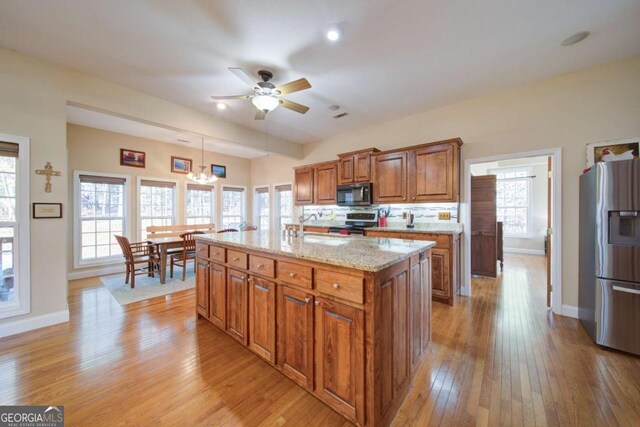 2656 Panorama Dr, Sautee Nacoochee, GA 30571 - kitchen featuring appliances with stainless steel finishes, brown cabinetry, light wood-style flooring, and ceiling fan