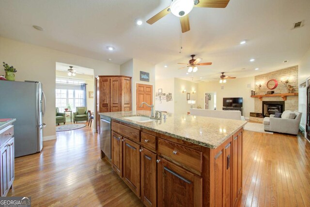 2656 Panorama Dr, Sautee Nacoochee, GA 30571 - kitchen featuring stainless steel appliances, ceiling fan, a large fireplace, light wood-style flooring, and recessed lighting