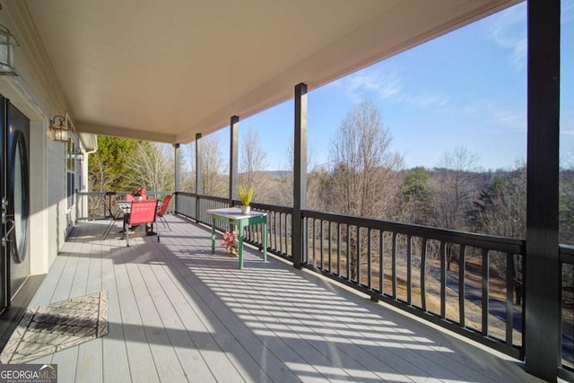 deck with outdoor dining area