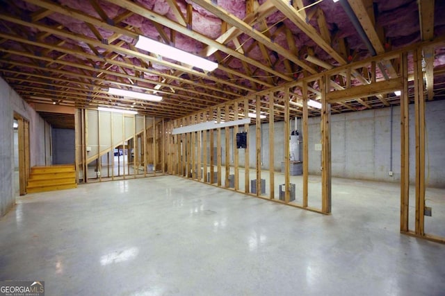 unfinished basement featuring water heater