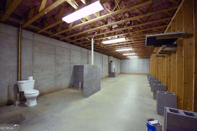 unfinished basement featuring gas water heater