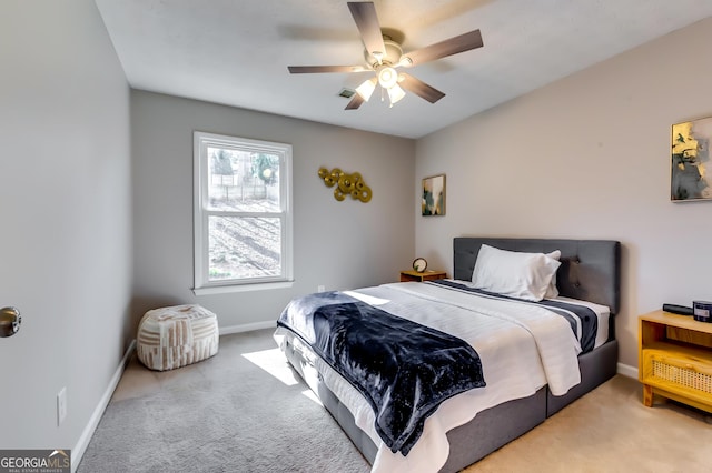 carpeted bedroom with a ceiling fan and baseboards