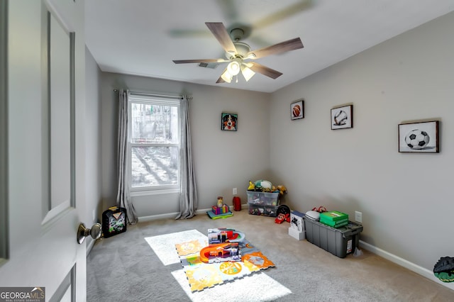 rec room featuring light carpet, baseboards, and a ceiling fan