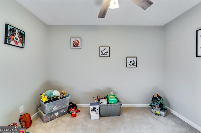 rec room featuring carpet, ceiling fan, and baseboards