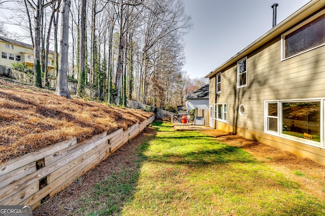 view of yard with fence and a deck