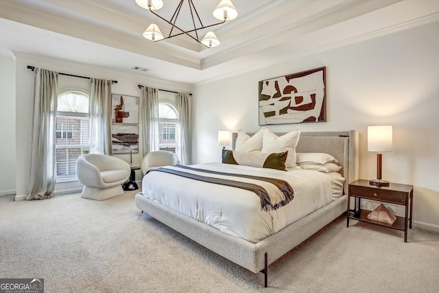 bedroom with a tray ceiling, a notable chandelier, visible vents, ornamental molding, and carpet flooring