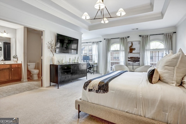 bedroom with light carpet, visible vents, a tray ceiling, and crown molding