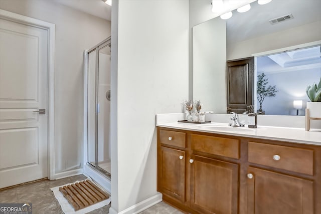 bathroom with a stall shower, visible vents, vanity, and tile patterned floors