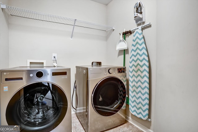 laundry room featuring laundry area, light tile patterned floors, and washer and dryer