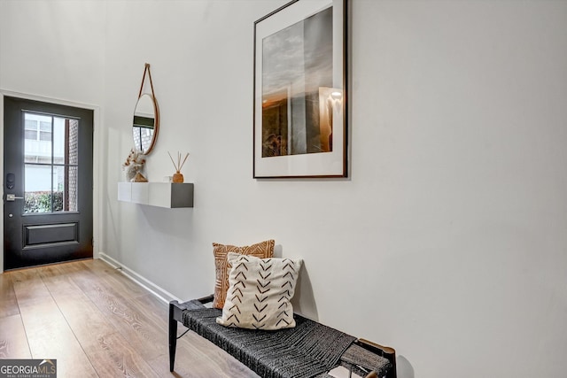 entrance foyer with light wood-style floors and baseboards