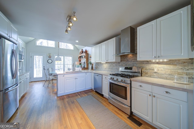 210 Wrights Mill Way, Canton, GA 30115 - kitchen with stainless steel appliances, wall chimney range hood, a peninsula, white cabinets, and backsplash