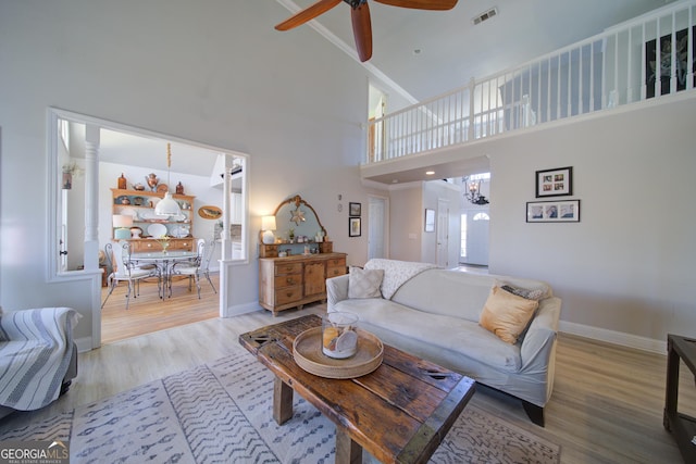 210 Wrights Mill Way, Canton, GA 30115 - living room with wood finished floors, baseboards, a towering ceiling, ceiling fan, and a chandelier