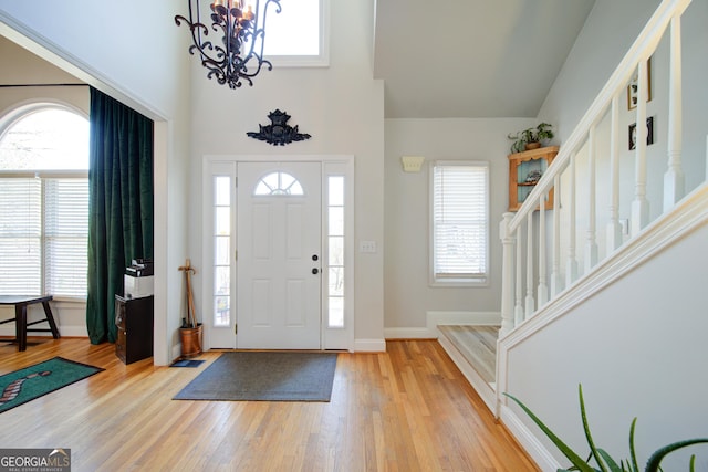 210 Wrights Mill Way, Canton, GA 30115 - entryway with a towering ceiling, a chandelier, plenty of natural light, and light wood-style floors
