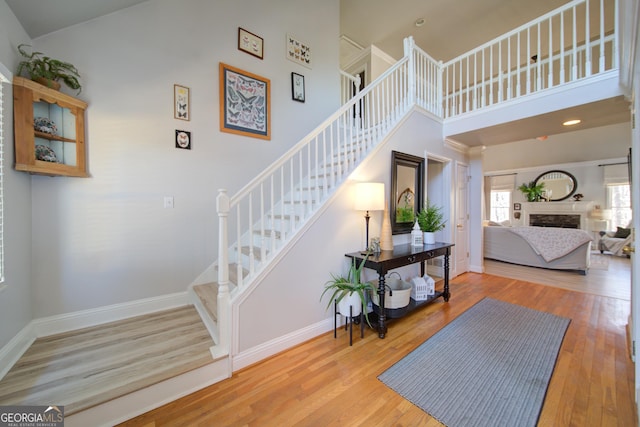 210 Wrights Mill Way, Canton, GA 30115 - stairs featuring a high ceiling, wood finished floors, baseboards, and a fireplace