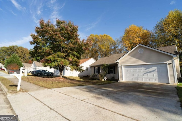 single story home with concrete driveway and an attached garage