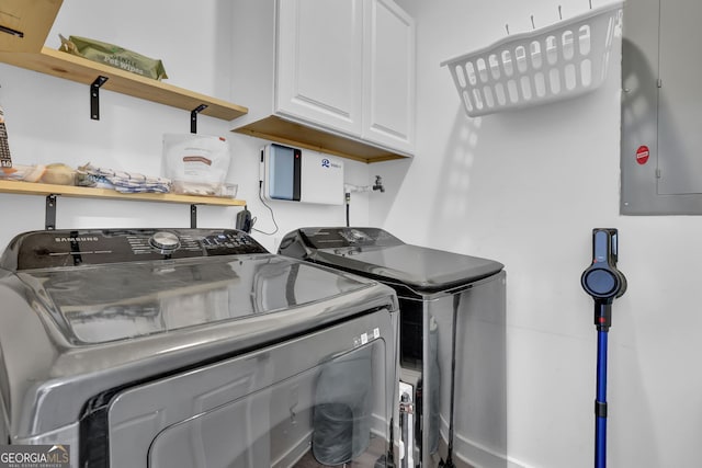 washroom featuring cabinet space, electric panel, and independent washer and dryer