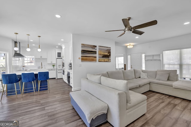 living room featuring recessed lighting, ceiling fan, and wood finished floors