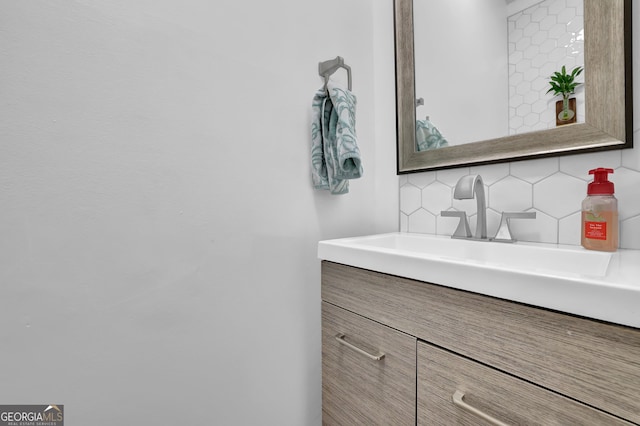 bathroom with tasteful backsplash and vanity