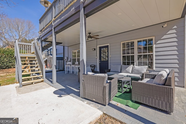 view of patio featuring outdoor dining area, ceiling fan, stairs, and an outdoor hangout area