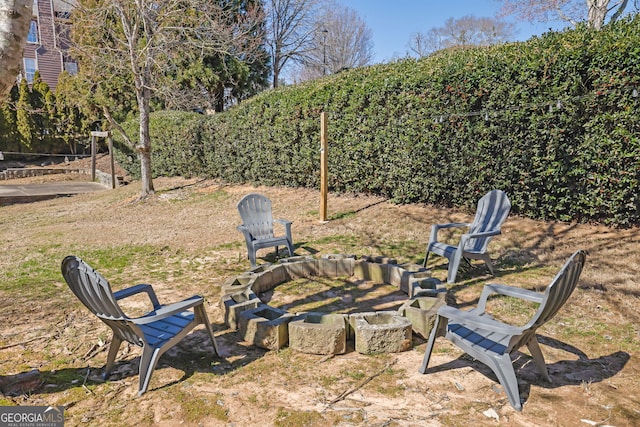 view of yard with an outdoor fire pit