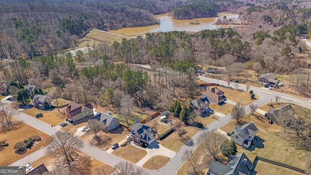 bird's eye view featuring a forest view and a water view