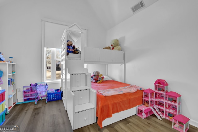 bedroom featuring visible vents, baseboards, and wood finished floors