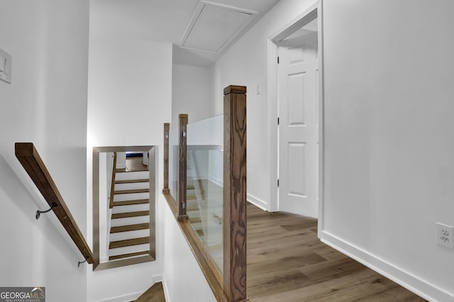 stairs with baseboards and wood finished floors